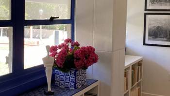 A corner of a room, with flowers and a small sculpture, at the Stavros Niarchos Foundation (SNF) Center for the Study of Hellenic Culture at the University of California, Los Angeles